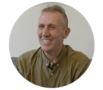 Man smiling in a green shirt with nice teeth