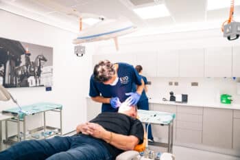 Clinician treating a patient during their full mouth dental implants treatment