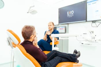 EvoDental patient talking with a clinician during a check-up